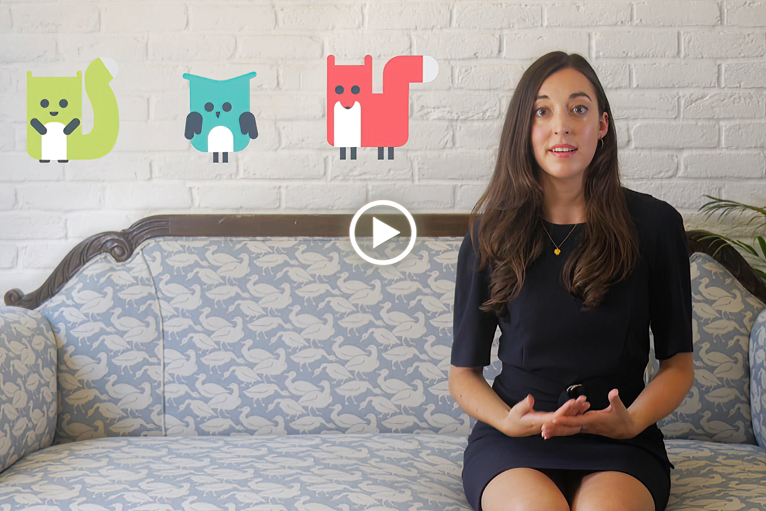 A person wearing a VR headset in a dark room lit with red and blue lights, smiling and reaching forward as if interacting with virtual objects.